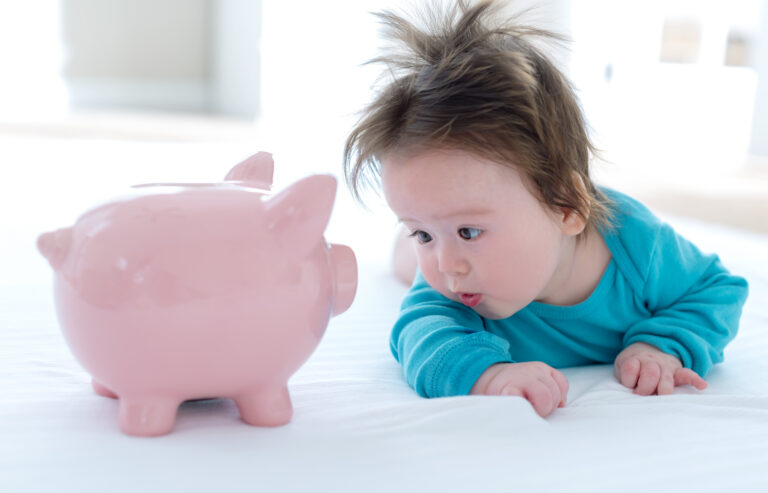 Baby boy with a piggy bank